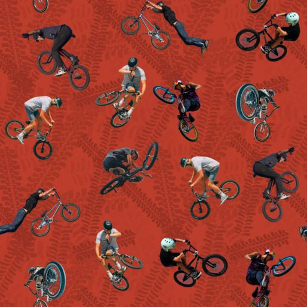 Fabric featuring a repeating pattern of people riding BMX bikes on a red background with tire track designs.