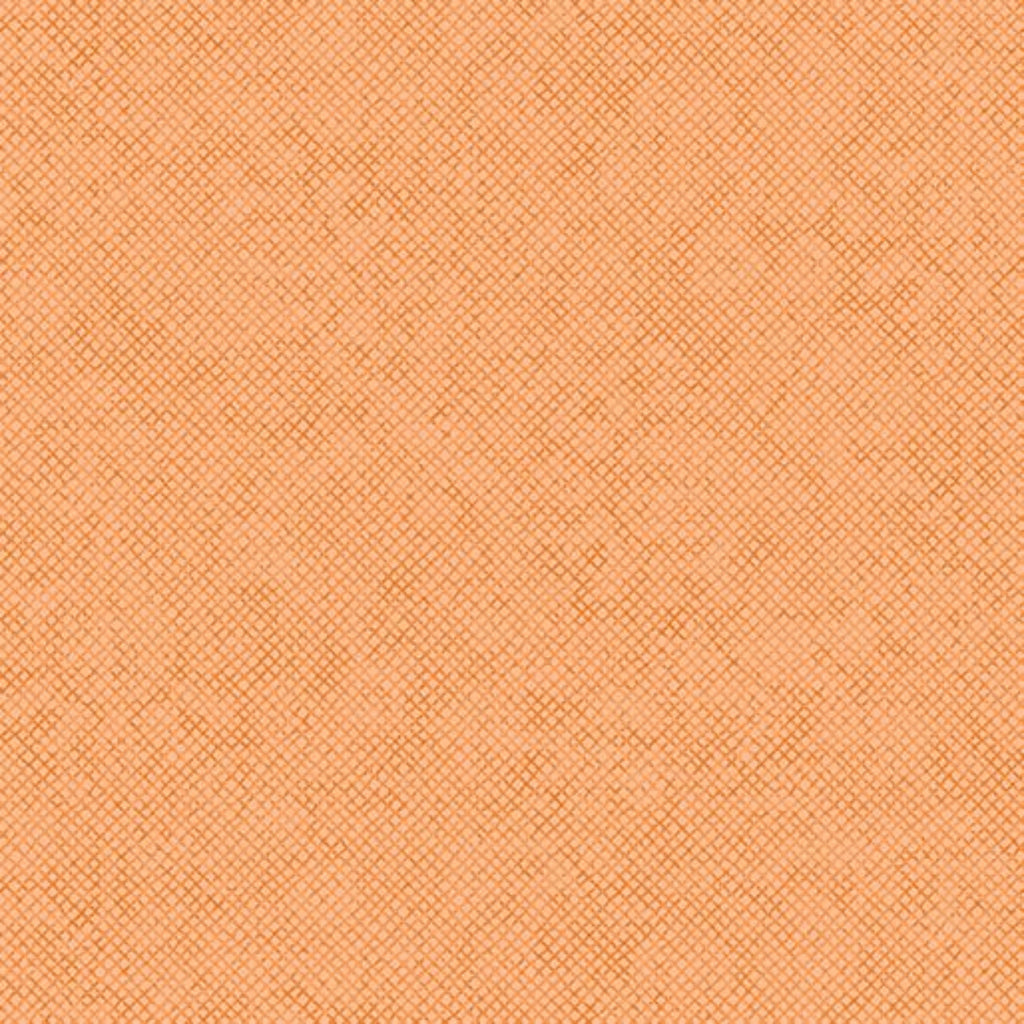 Close-up view of a textured apricot-colored fabric.