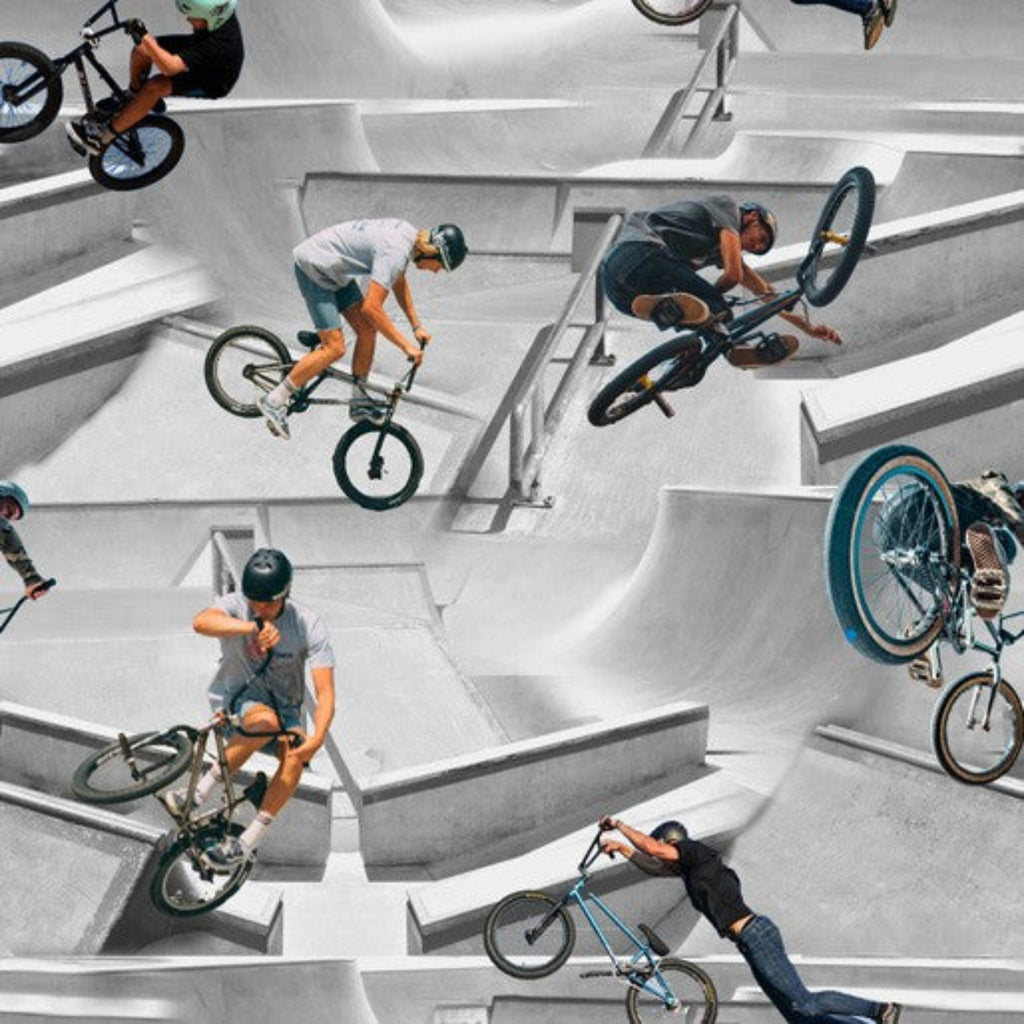A patterned fabric featuring multiple images of BMX bikers performing tricks in a skatepark.