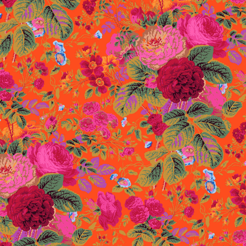 A vibrant piece of fabric featuring a floral pattern with orange, red, and green colors on a tomato-like background.