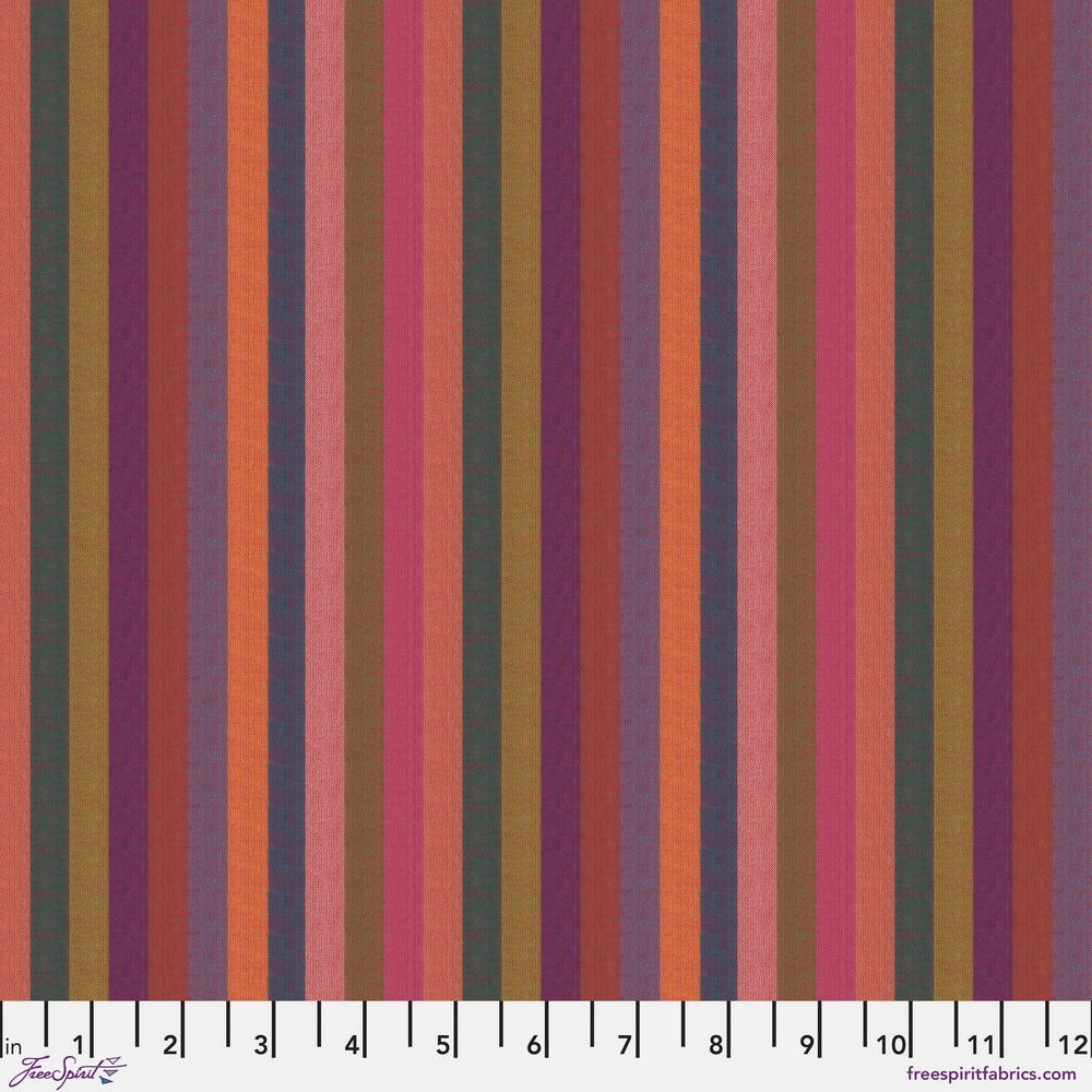 A woven fabric featuring narrow stripes in a range of colors including orange, pink, and sunset hues, with a label indicating the brand Kaffe Fassett and the pattern name WOVEN STRIPES.