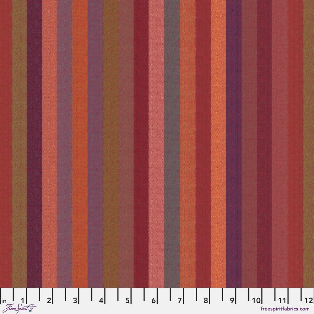 A woven fabric with broad stripes in red, orange, and purple colors, marked with measurements along the edge.