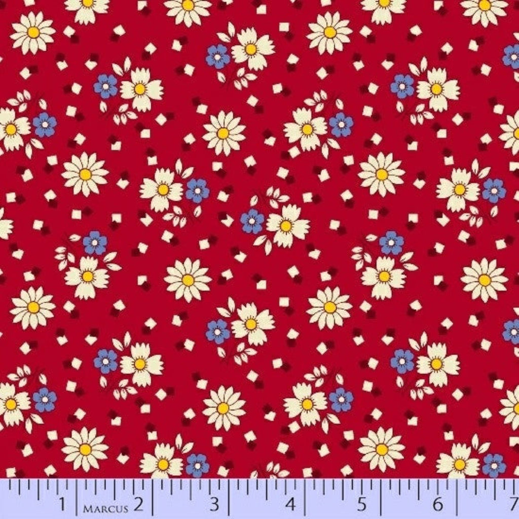 Floral pattern on red fabric with a ruler at the bottom