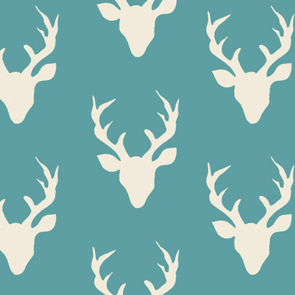 Pattern of white deer heads on a teal background
