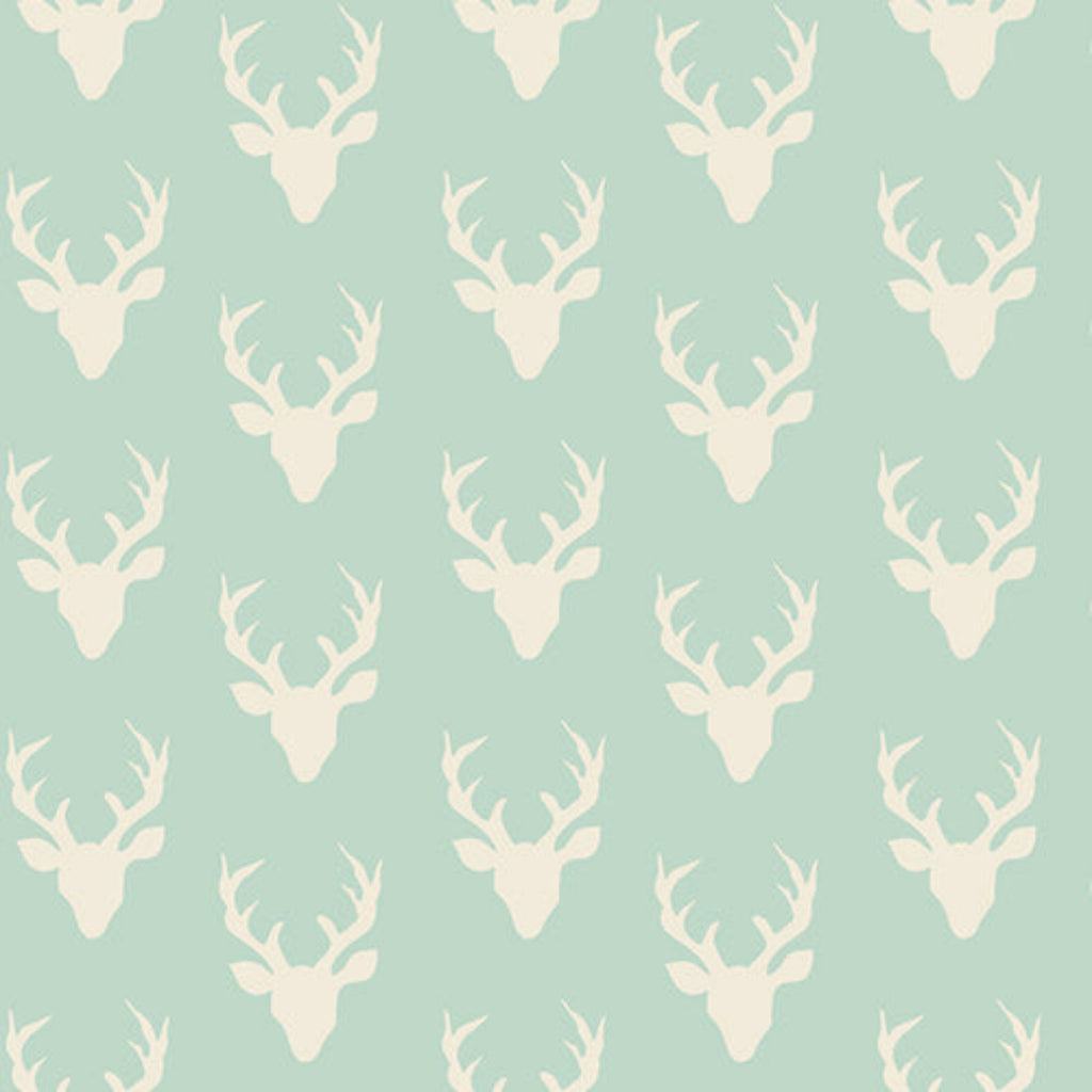 Pattern of white deer heads on a light blue background