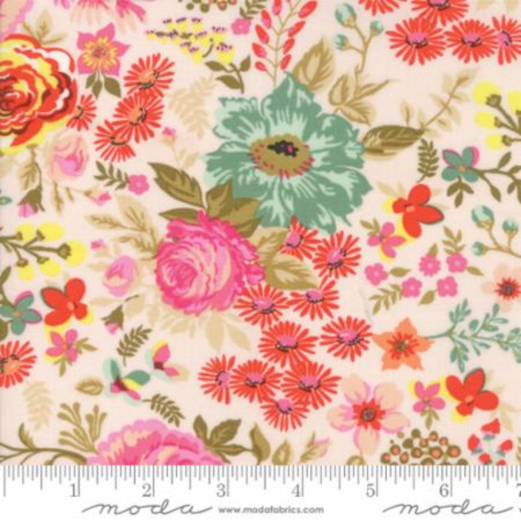 A piece of fabric featuring a floral pattern with prominent pink, green, and red flowers, and yellow background, with a ruler at the bottom showing the measurement scale.