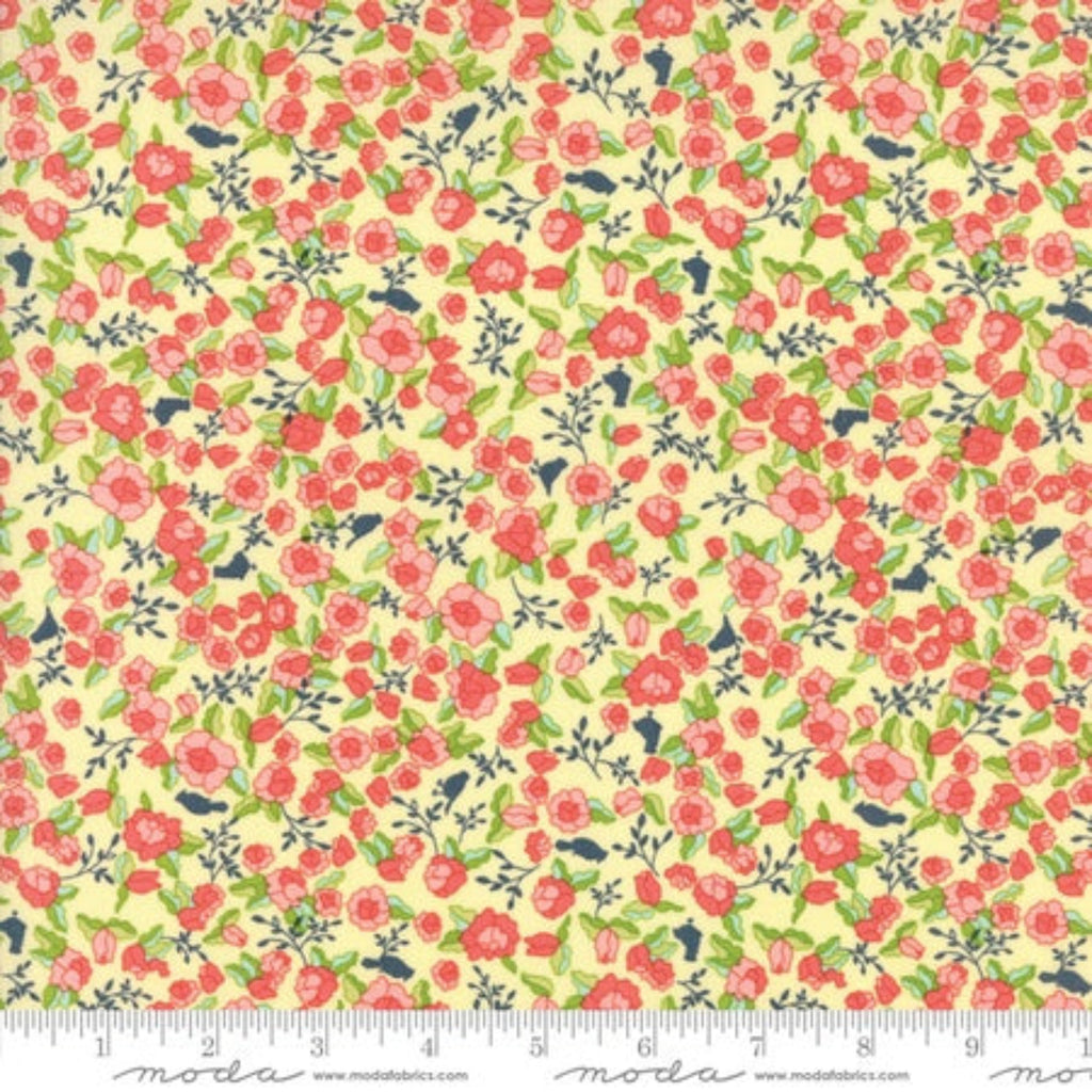 A piece of fabric featuring a floral pattern with pink and yellow flowers and green leaves on a beige background, with a measuring tape indicating the size.