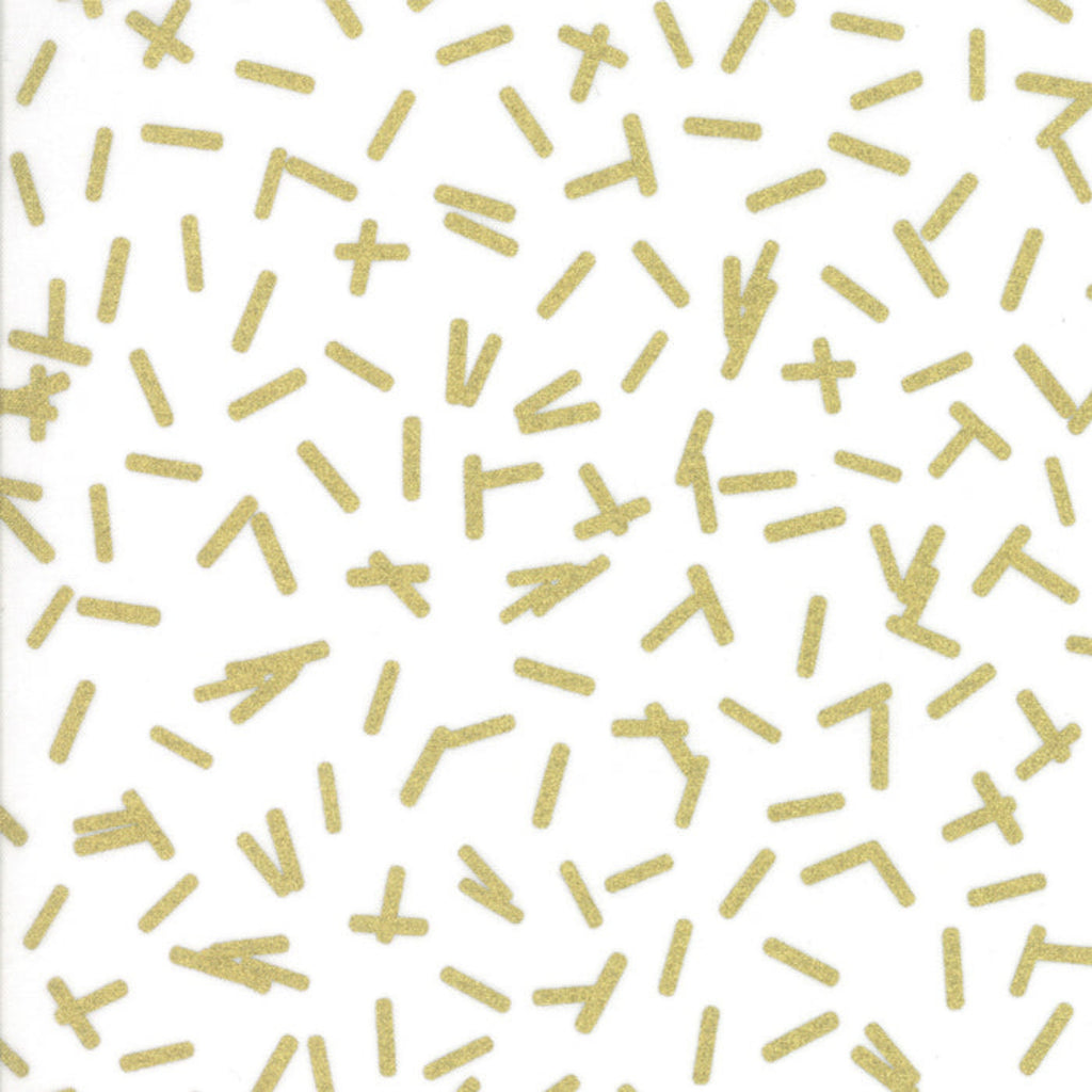 A piece of fabric featuring a white background with gold metallic geometric shapes.