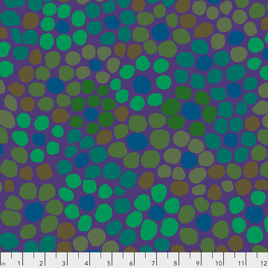 A fabric with a flower dot pattern in purple, green, and blue colors on a measuring background.