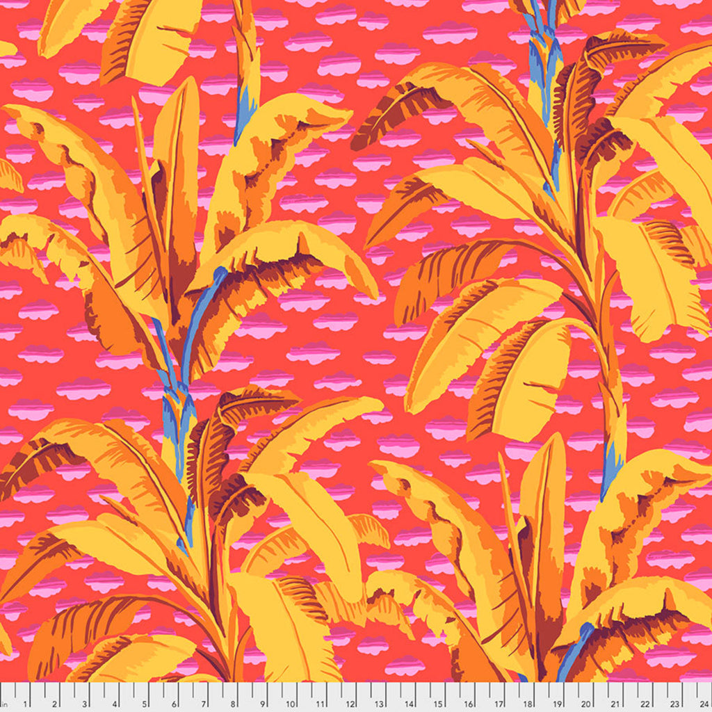 A piece of fabric featuring a vibrant print with banana trees in yellow and orange on a red background.