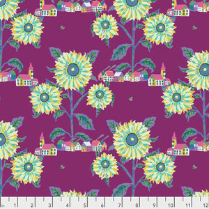 A piece of fabric with a floral pattern featuring sunflowers and a village design on a purple background.