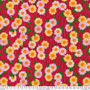 A vibrant piece of fabric featuring a repeating floral pattern with pink, red, and yellow flowers on a red background.
