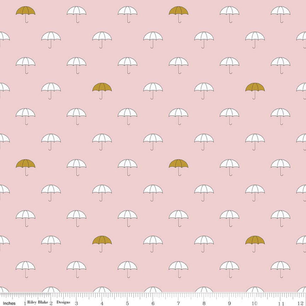 A fabric featuring a pattern of white umbrellas with gold accents on a pink background.