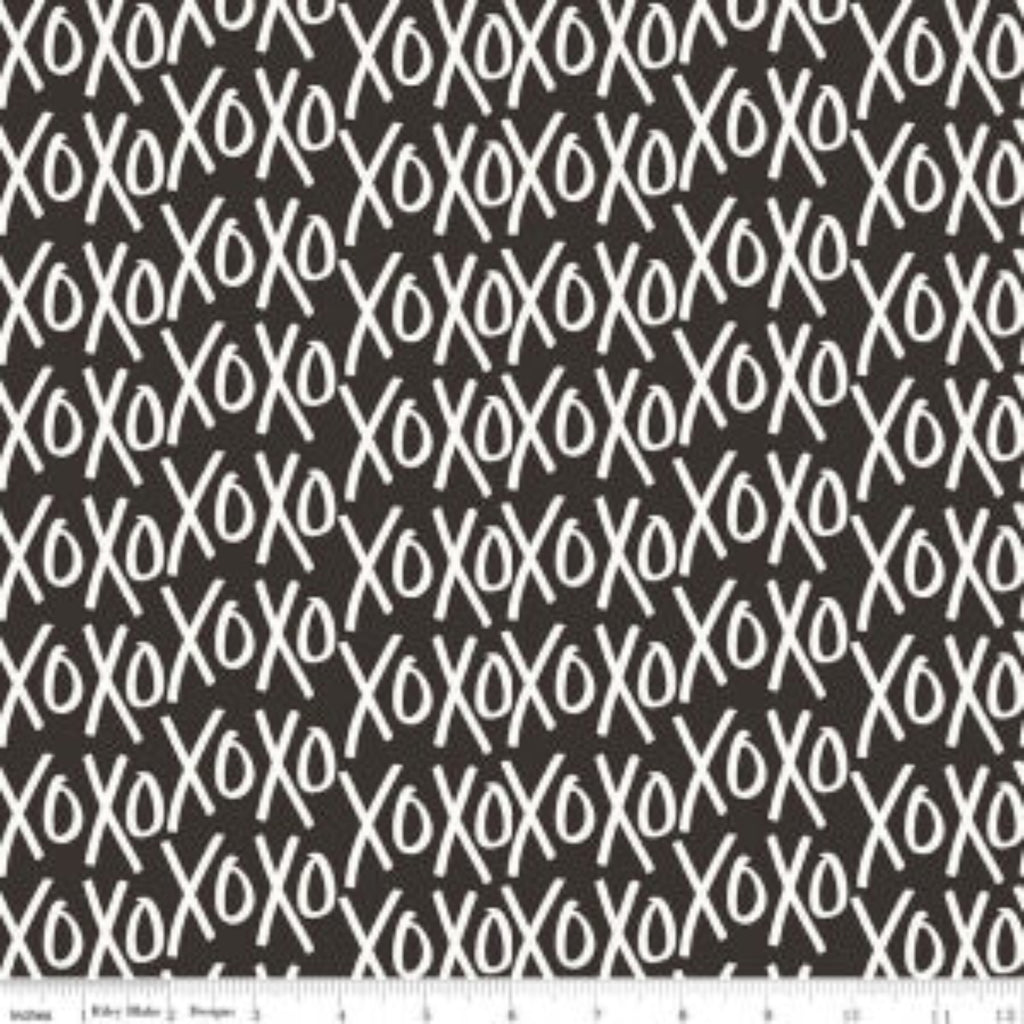 A fabric with a pattern of white Xo's on a black background.
