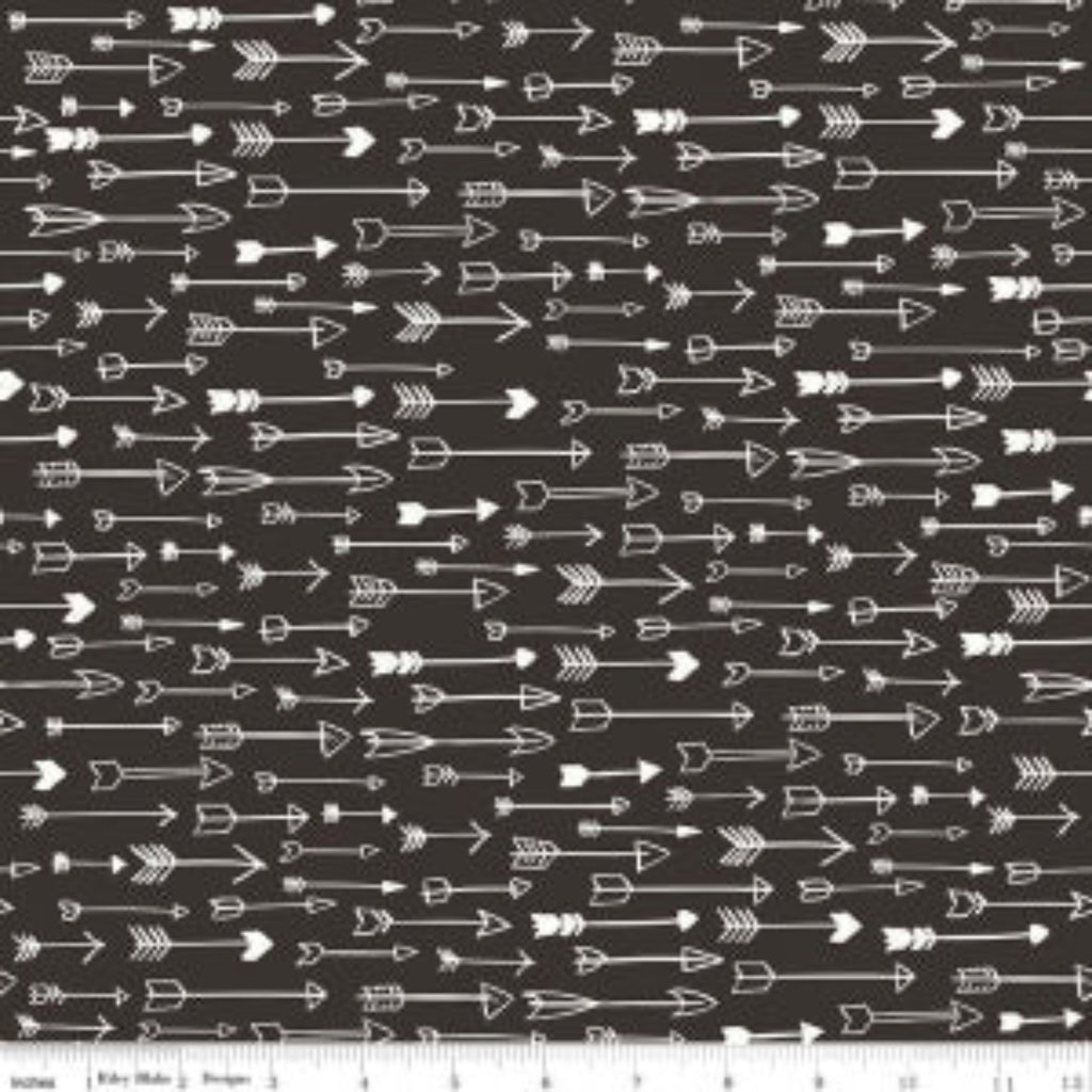 A fabric with a pattern of white arrows on a black background.