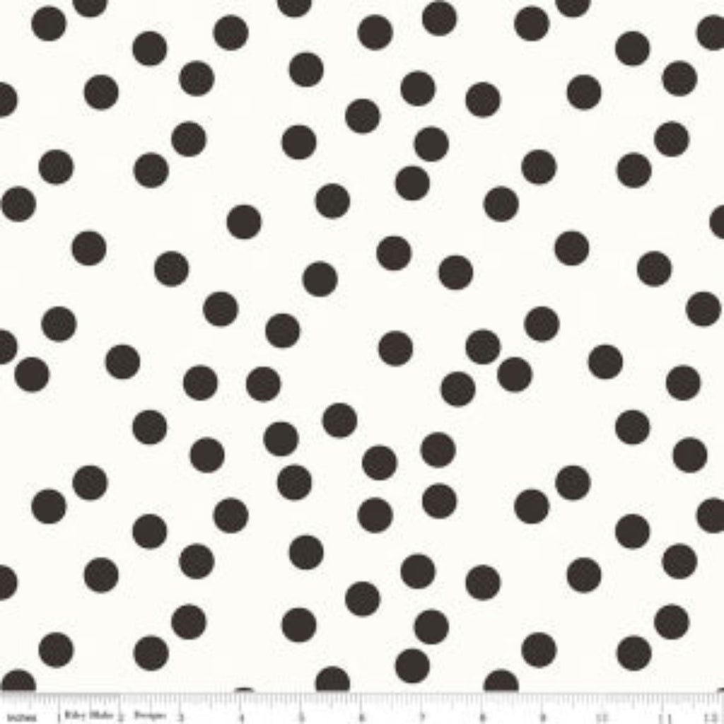 A fabric with a pattern of black dots on a white background, part of the "Yes, Please" collection.