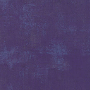 Grunge dark purple color swatch with a textured pattern