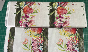 Floral fabric with green stripes on a cutting mat
