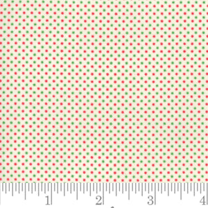A piece of fabric featuring a white background with a pattern of red and green dots, measuring 112cm in width, displayed next to a ruler for scale.