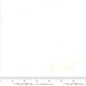 White fabric swatch with a ruler at the bottom for scale, featuring the 'moda' brand.
