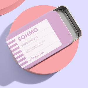 SOHMO spare buttons tin on a light purple background