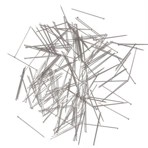 Collection of metal pins on a white background