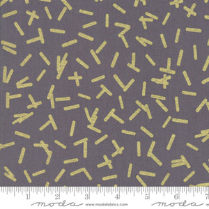 Fabric with yellow geometric pattern on gray background, featuring Moda label.