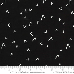 A fabric with a geometric pattern in black and white, showing various shapes such as triangles and straight lines, indicating a design by Zen Chic.