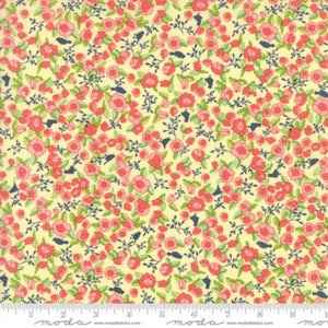 A piece of fabric featuring a floral pattern with pink and yellow flowers and green leaves on a beige background, with a measuring tape indicating the size.