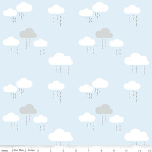 A piece of fabric featuring a blue sky with white clouds pattern, intended for use in sewing and crafting projects.