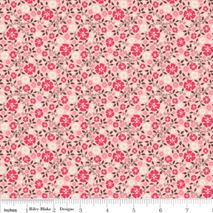 A fabric featuring a pink floral pattern on a beige background, labeled as part of the Cowboy Up collection.