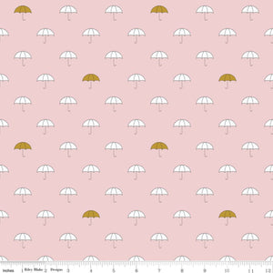 A fabric featuring a pattern of white umbrellas with gold accents on a pink background.