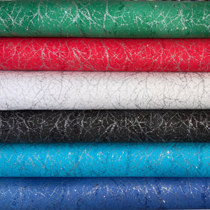 Collection of textured fabric rolls in green, red, white, black, and blue.