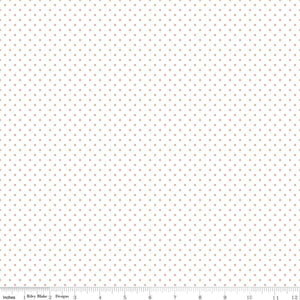 A piece of fabric featuring rose gold metallic dots on a white background, with a measuring label.